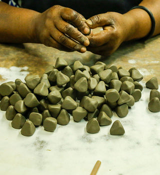 Kenyan artisan crafting clay to make Kazuri beads
